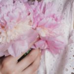 woman-holding-pink-flowers-1460837